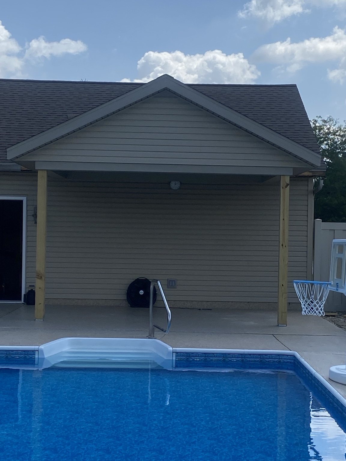 Finished garage exterior beside a swimming pool