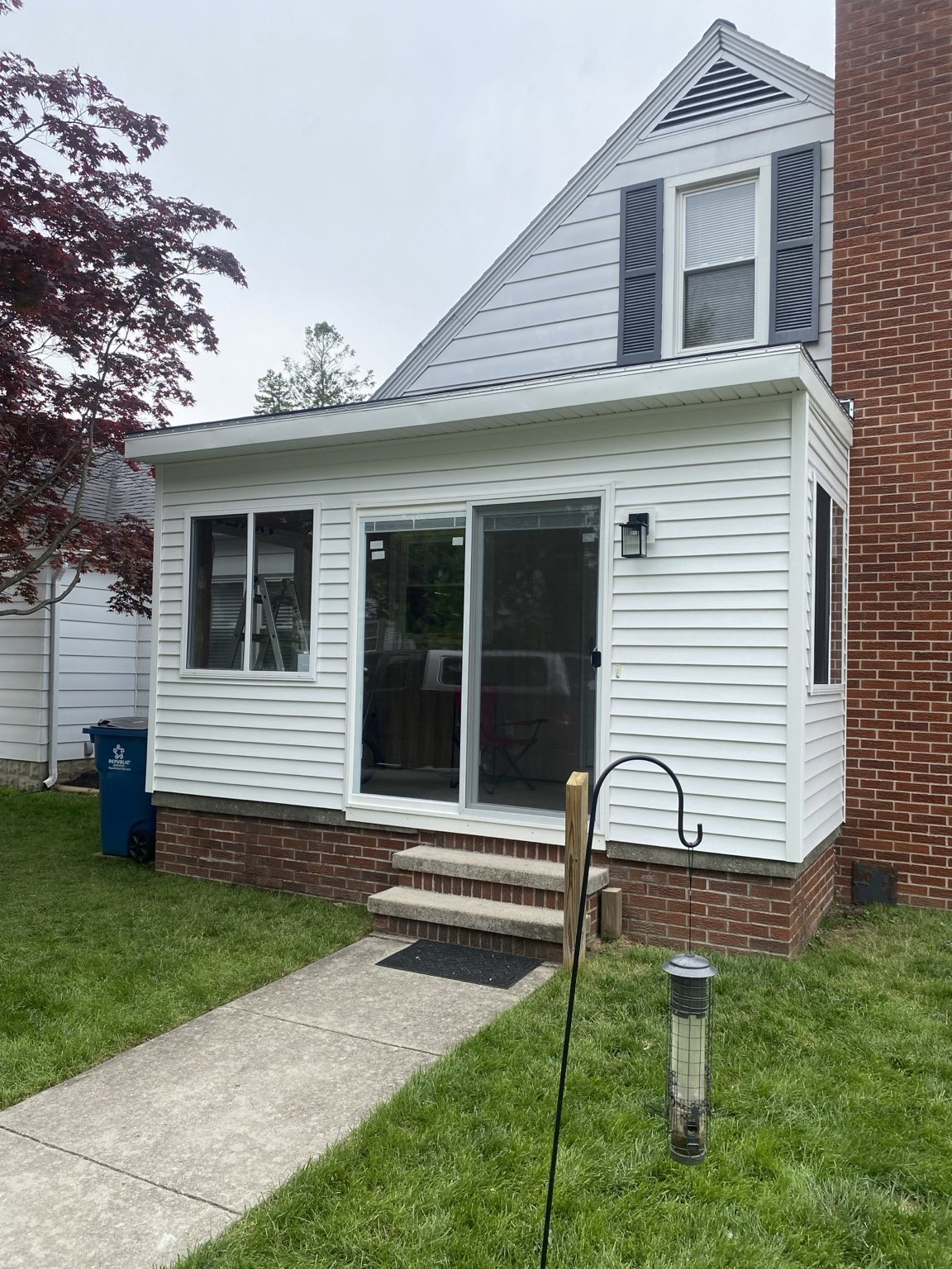White siding and windows on a finished home addition