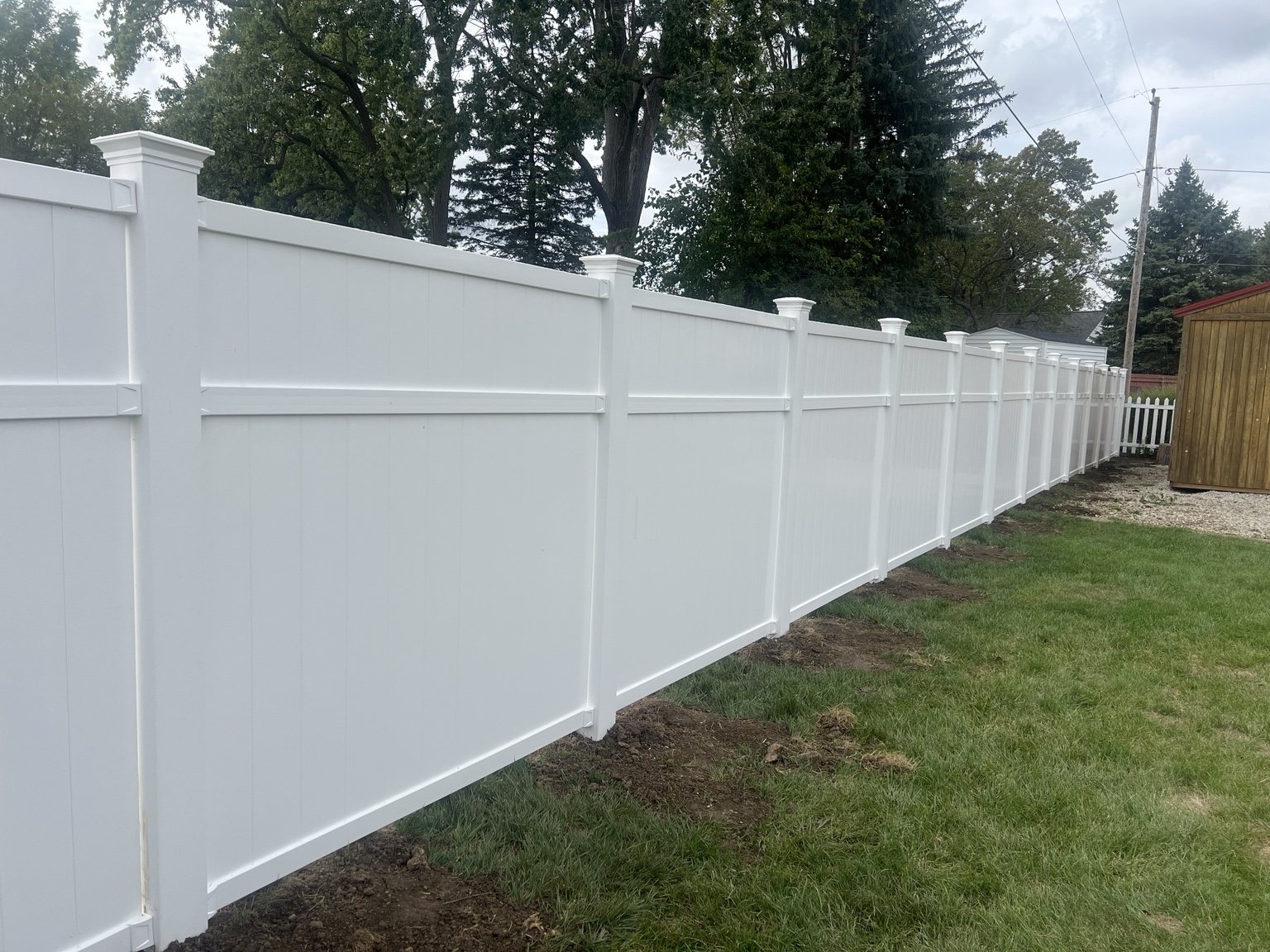 Long white privacy fence with finished panels